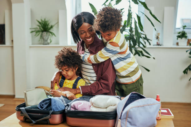 istock Mother and children bonding while packing suitcase at home 1385502200