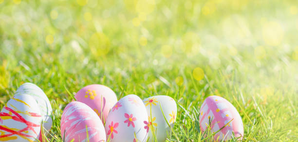 istock Happy Easter! Easter  eggs and cute bunny  on green grass in the  Meadow 1385503433