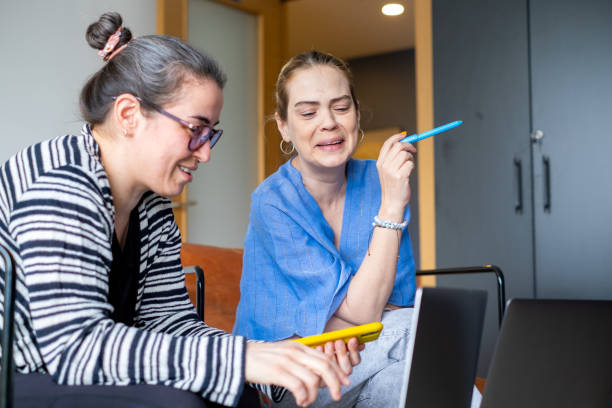 istock Two business coworkers using laptop 1385503547