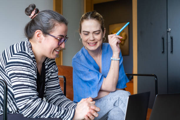 istock Two business coworkers using laptop 1385504154