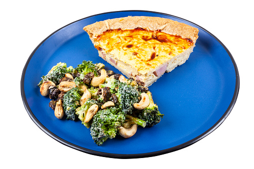 Ham and Cheese Quiche with brocoli salad isolated on a white background