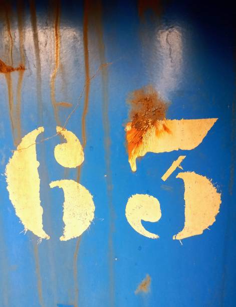istock Photograph of character painted on blue background with rust streaks 1385506038