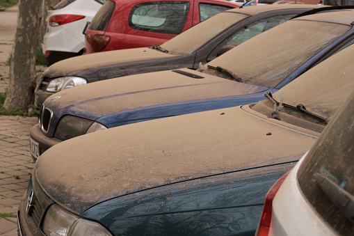 Cars covered by orange dust from Sahara in Madrid, Spain on March 12, 2022. Storm Celia.
