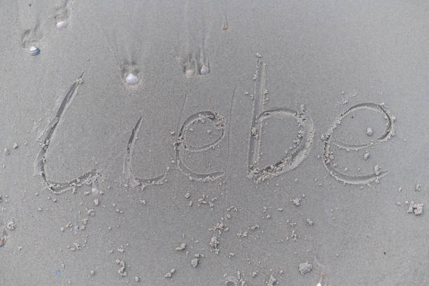 the word love (Liebe) has been written in the sand