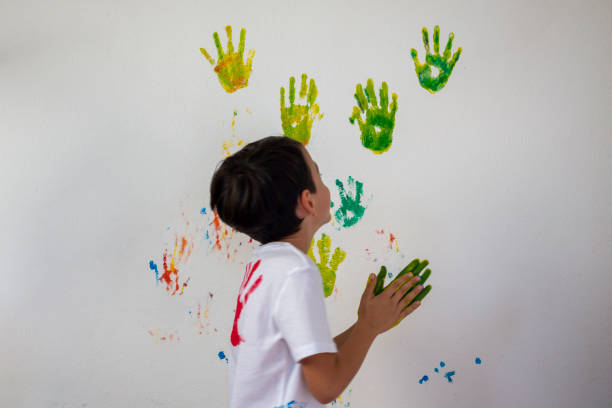 istock Boy Showing Colorful Paint on His Hands 1385509018