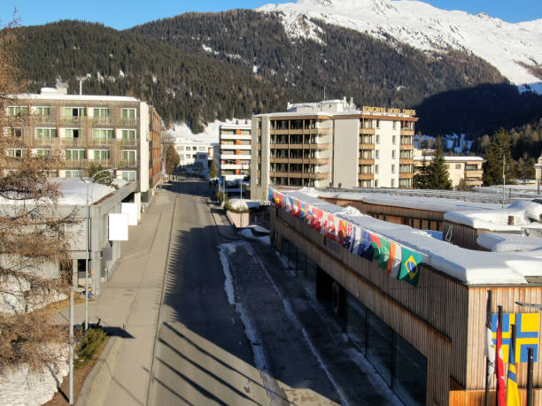 Davos Forum entrance with flags. Mountains in the background.