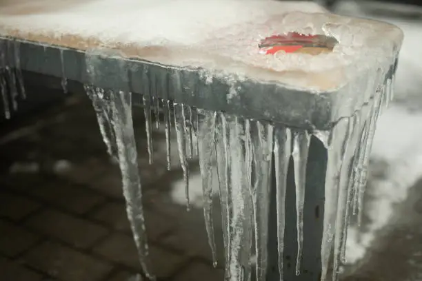 Photo of Icy seat. Details of freezing rain Ice outside. Aftermath of storm.