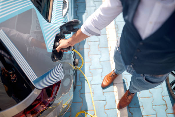 istock Busnessman charging his electric car 1385511537