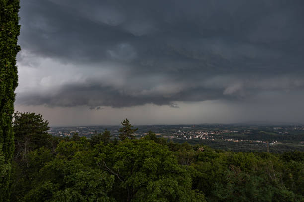 istock panoramic view in low key on a plain area landscape completely covered by extremely dark gray clouds bringing an powerful rainy storm above the land 1385513055