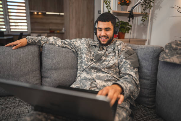 Soldier using laptop at home