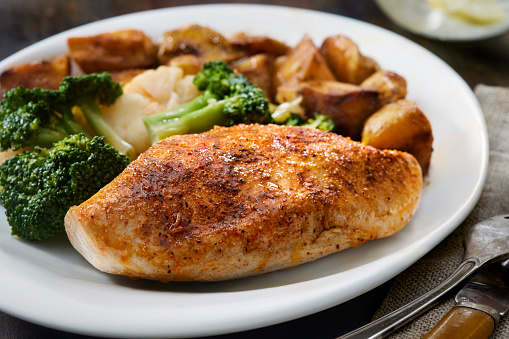 Seasoned Chicken Breast with Roasted Potatoes and Steamed Broccoli and Cauliflower