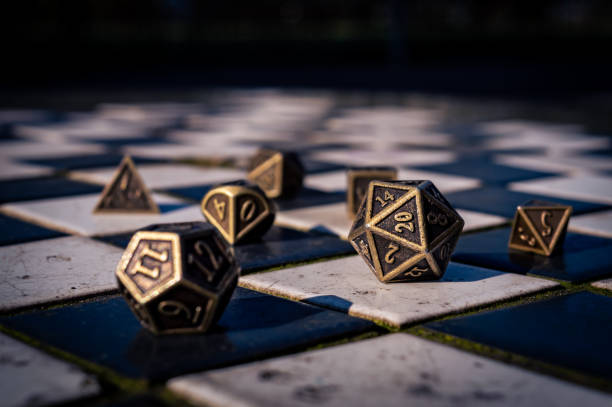 Close-up of a set of roleplaying dice on black and white tiles stock photo