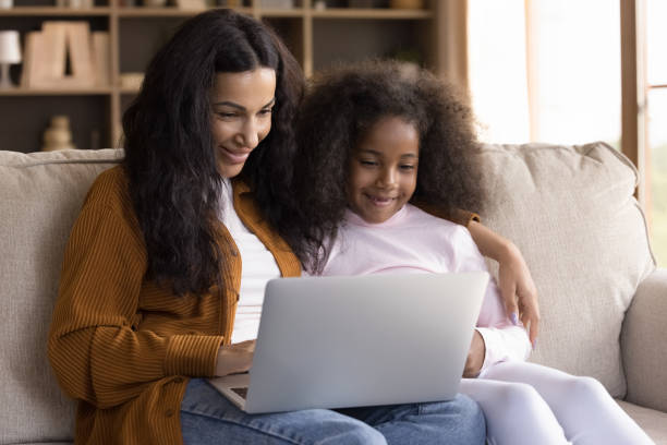 istock Happy beautiful African American family using computer. 1385517838
