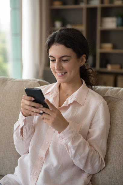istock Happy attractive millennial Hispanic woman using smartphone. 1385518009