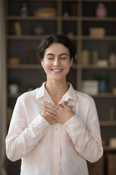 istock Vertical image joyful Hispanic woman feeling thankful. 1385518010