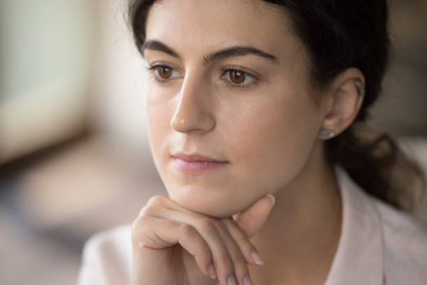 istock Dreamy millennial Hispanic woman looking in distance. 1385518018