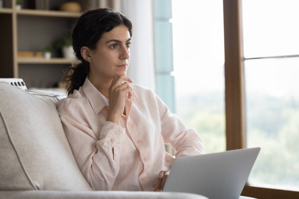 istock Pensive young Hispanic woman working on computer. 1385518020