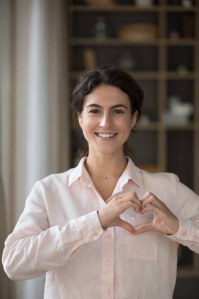 istock Happy kind female volunteer expressing support, charity concept. 1385519903