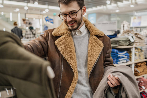 istock Young man buys clothes in a store 1385520035