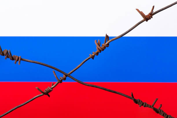 istock Barbed wire on the background of Russian flag 1385520173