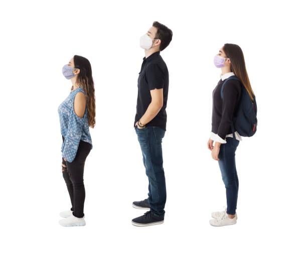 istock Side view of three students with masks standing 1385520309