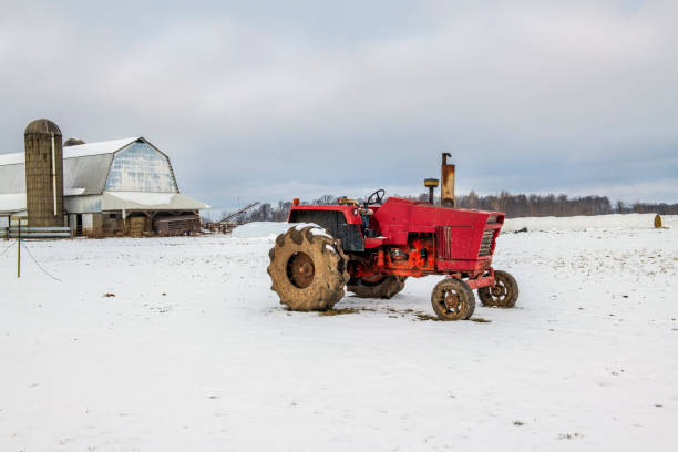 Old tractor sitting in the snow