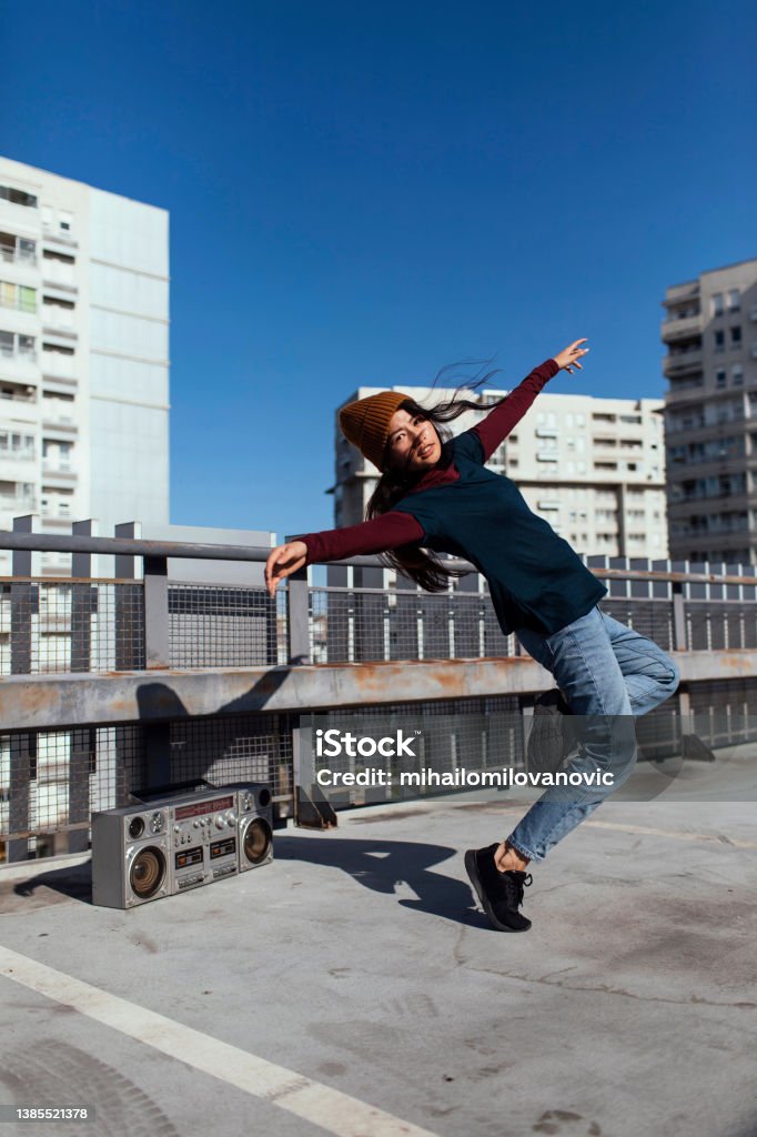 Dance on the roof Carefree beautiful girl cheerful dancing on roof Dancing Stock Photo