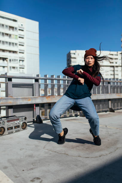 istock Cheerful young woman dancing 1385521386