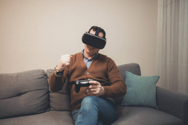istock A man playing video game using VR and gamepad at home 1385522611