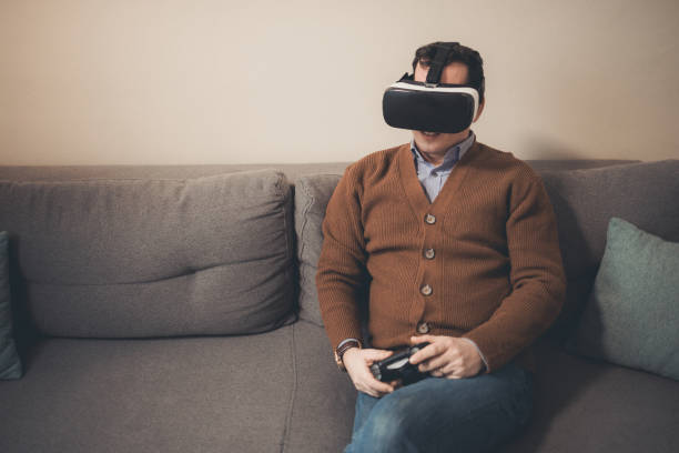 istock A man playing video game using VR and gamepad at home 1385522781