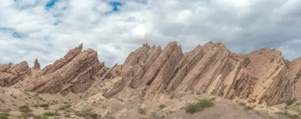 Photo of Quebrada de las flechas (Arrows Creek), Argentina Route 40. Stunning spiky rock formations pointing diagonally upwards and thus resembling arrows, Salta Province, Argentina