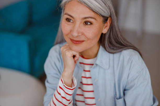 istock Joyful woman propping up head with hand and smiling 1385526355
