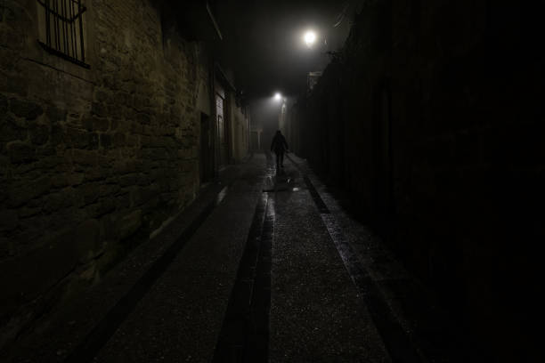 istock Woman in dark street 1385530222