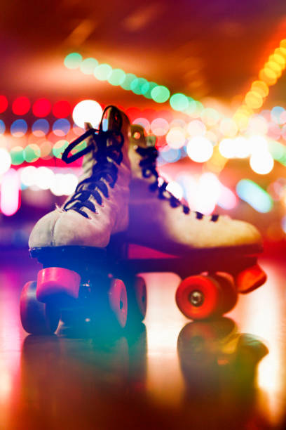 Retro Roller Skates on a Roller Skating Rink A pair of retro roller skates on a roller skating rink. roller rink stock pictures, royalty-free photos & images