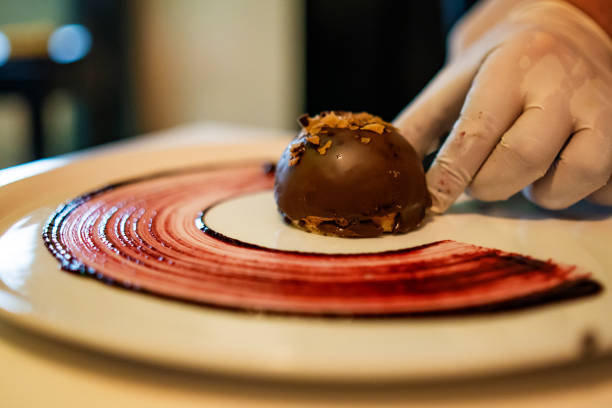 Unrecognizable male hands decorating chocolate biscuit