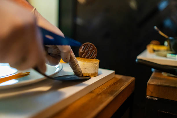 istock Unrecognizable male hands putting orange cookie on desk 1385530360