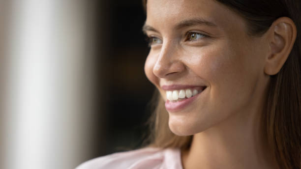 istock Relaxed dreamy young woman using cellphone, reading New Year congratulations. 1385530398