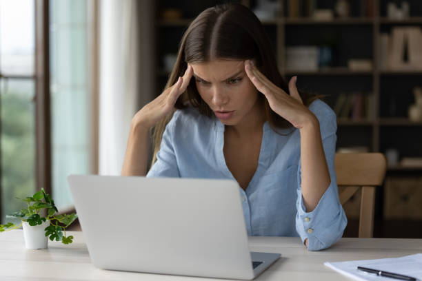 istock Thoughtful young beautiful woman working with documents at home. 1385531141