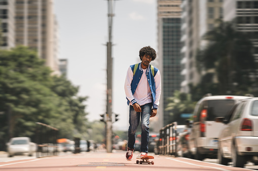 Man skateboarding on Avenida Paulista in Sao Paulo, Brazil