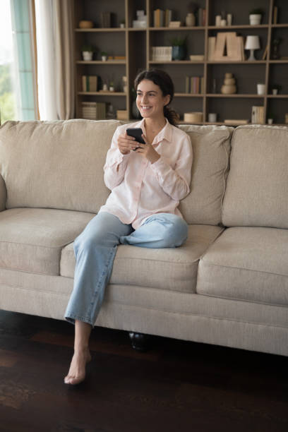 istock Relaxed millennial Hispanic woman using cellphone at home. 1385537930