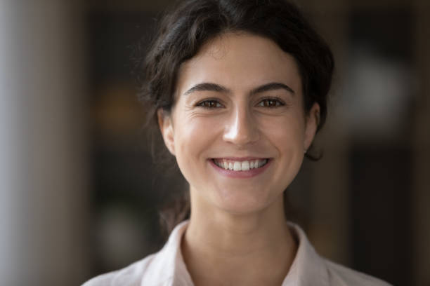 istock Head shot close up young Hispanic woman looking at camera. 1385537952