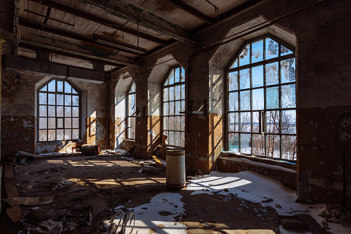 Old broken empty abandoned industrial building interior.