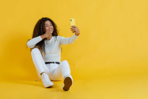 african american woman gesturing OK, on a video call stock photo