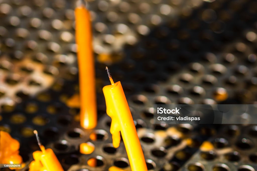 Burning melting candles in memory of the dead, close up. Advent Stock Photo