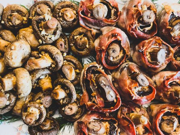 Mushrooms covered with bacon and without.