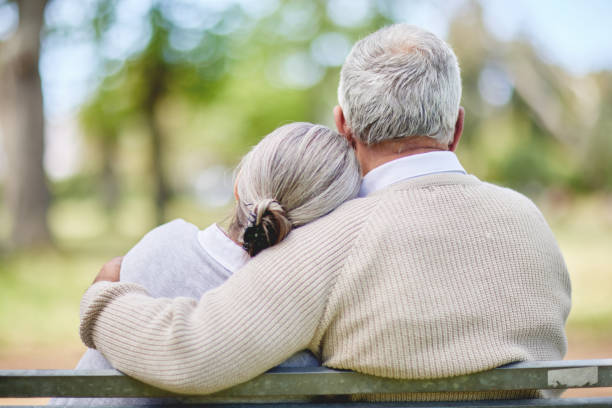 shot of a senior couple bonding outdoors together - couple loving married affectionate imagens e fotografias de stock