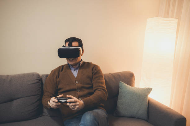 istock A man playing video game using VR and gamepad at home 1385544007
