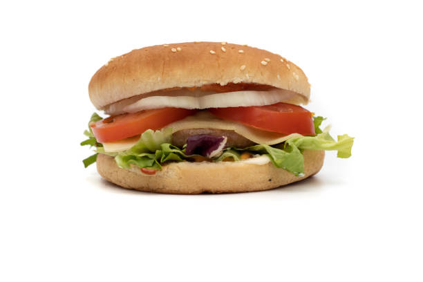 istock A hamburger, with the ingredients, lettuce, cabbage, cucumber, tomato, onion, cheese, ketchup, mayonnaise 1385544332