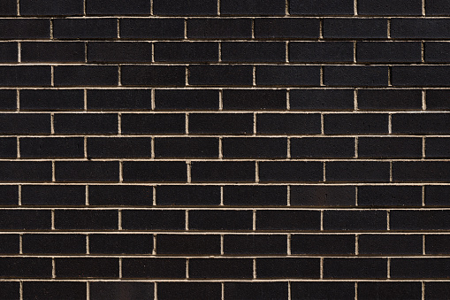 Section of a black brick wall.