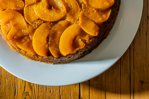 Peach upside-down cake on a rustic wooden table